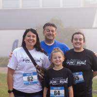 A family posing for a photo prior to the event